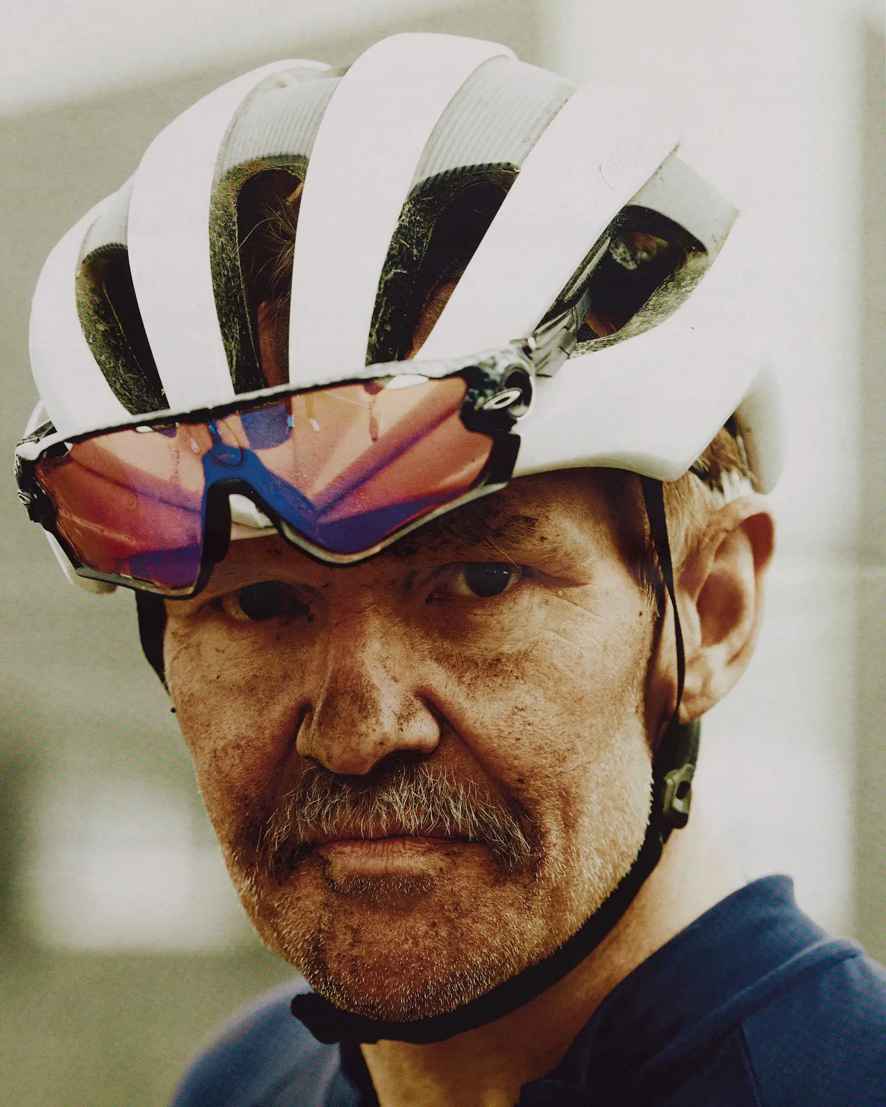 Racer moments after finishing the gravel bike race, with dirt on his face. The Rift gravel bike race takes place in Iceland annually. Shot for a personal project and self-published tabloid size newsprint that covers The Rift Gravel Bike Race in Iceland in 2023.