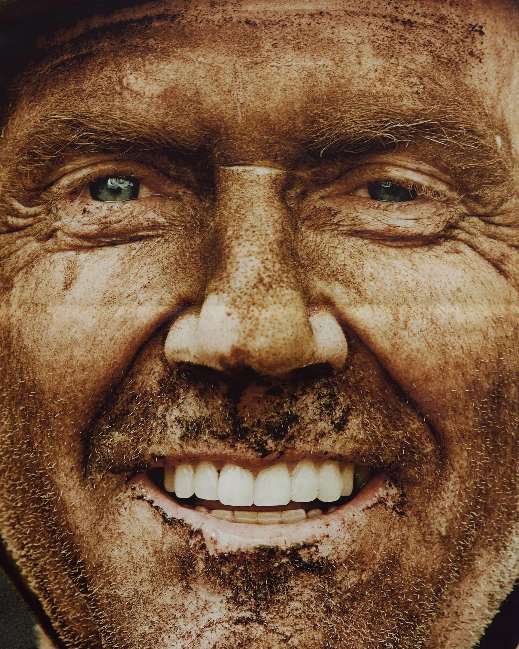 Racer moments after finishing the gravel bike race, with dirt on his face. The Rift gravel bike race takes place in Iceland annually. Shot for a personal project and self-published tabloid size newsprint that covers The Rift Gravel Bike Race in Iceland in 2023.