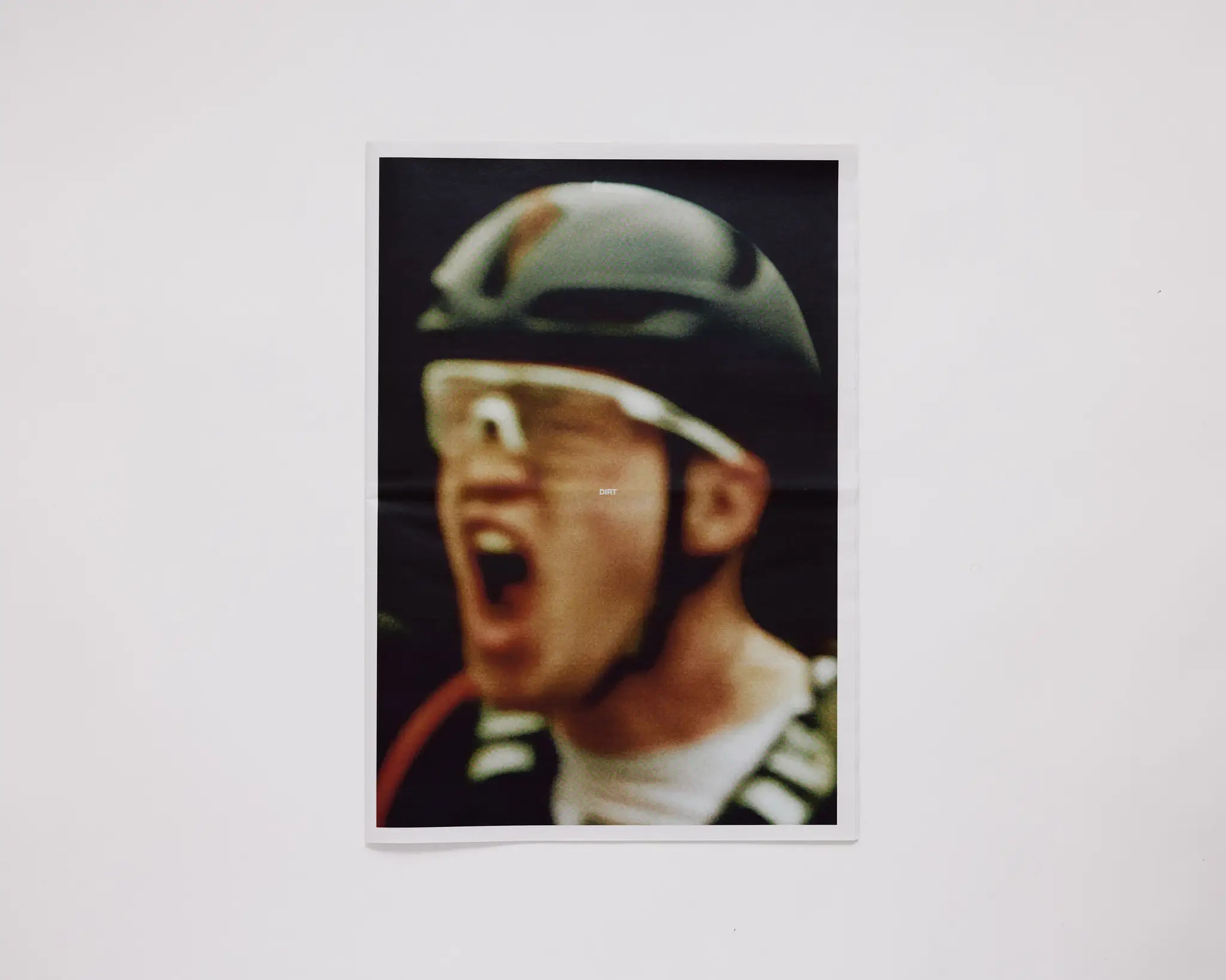 Gravel bike racer crossing the finish line, yelling in excitement. The Rift gravel bike race takes place in Iceland annually. Shot for a personal project and self-published tabloid size newsprint that covers The Rift Gravel Bike Race in Iceland in 2023.