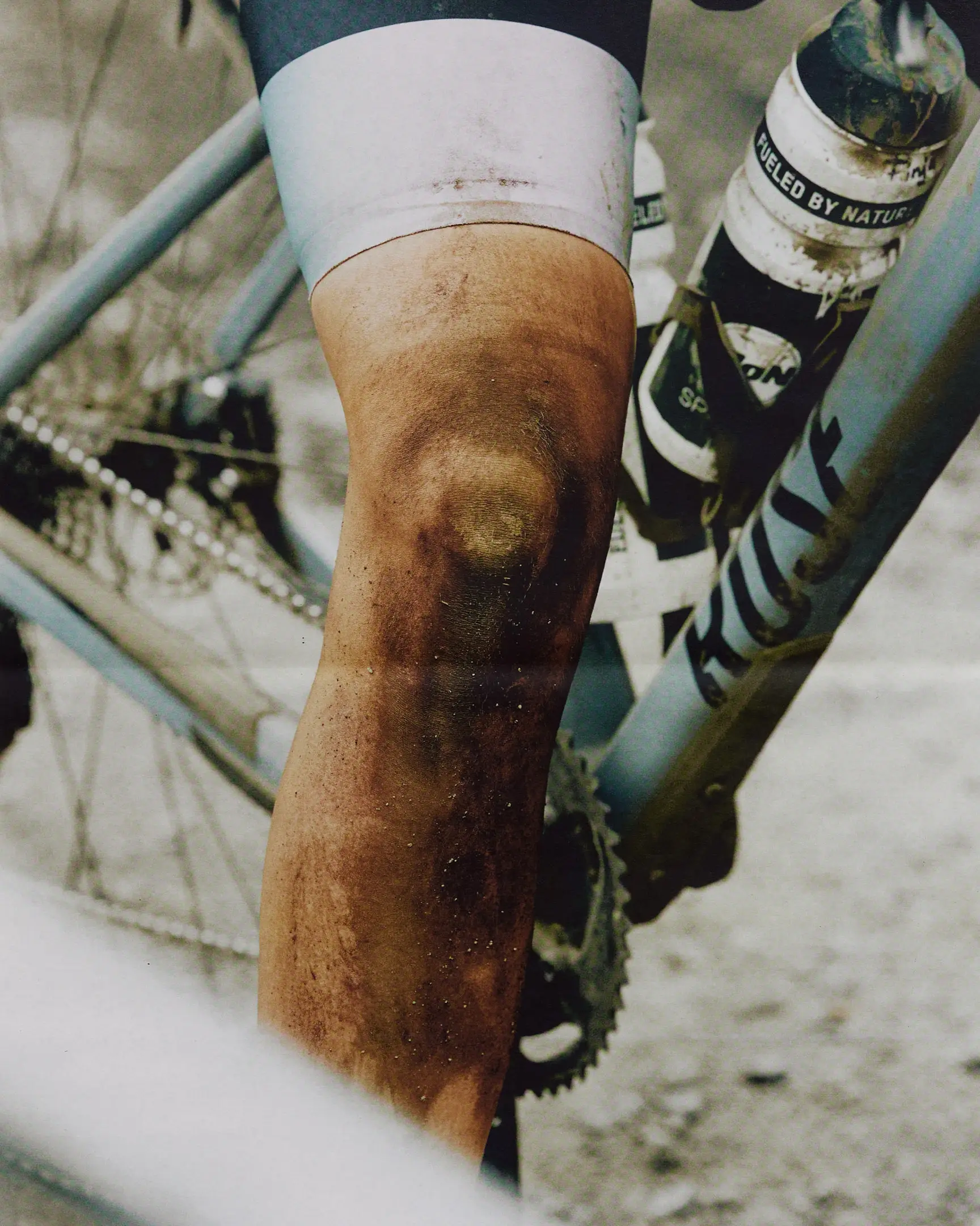 Bike racer's leg full of rocks and dirt. The Rift gravel bike race takes place in Iceland annually. Shot for a personal project and self-published tabloid size newsprint that covers The Rift Gravel Bike Race in Iceland in 2023.