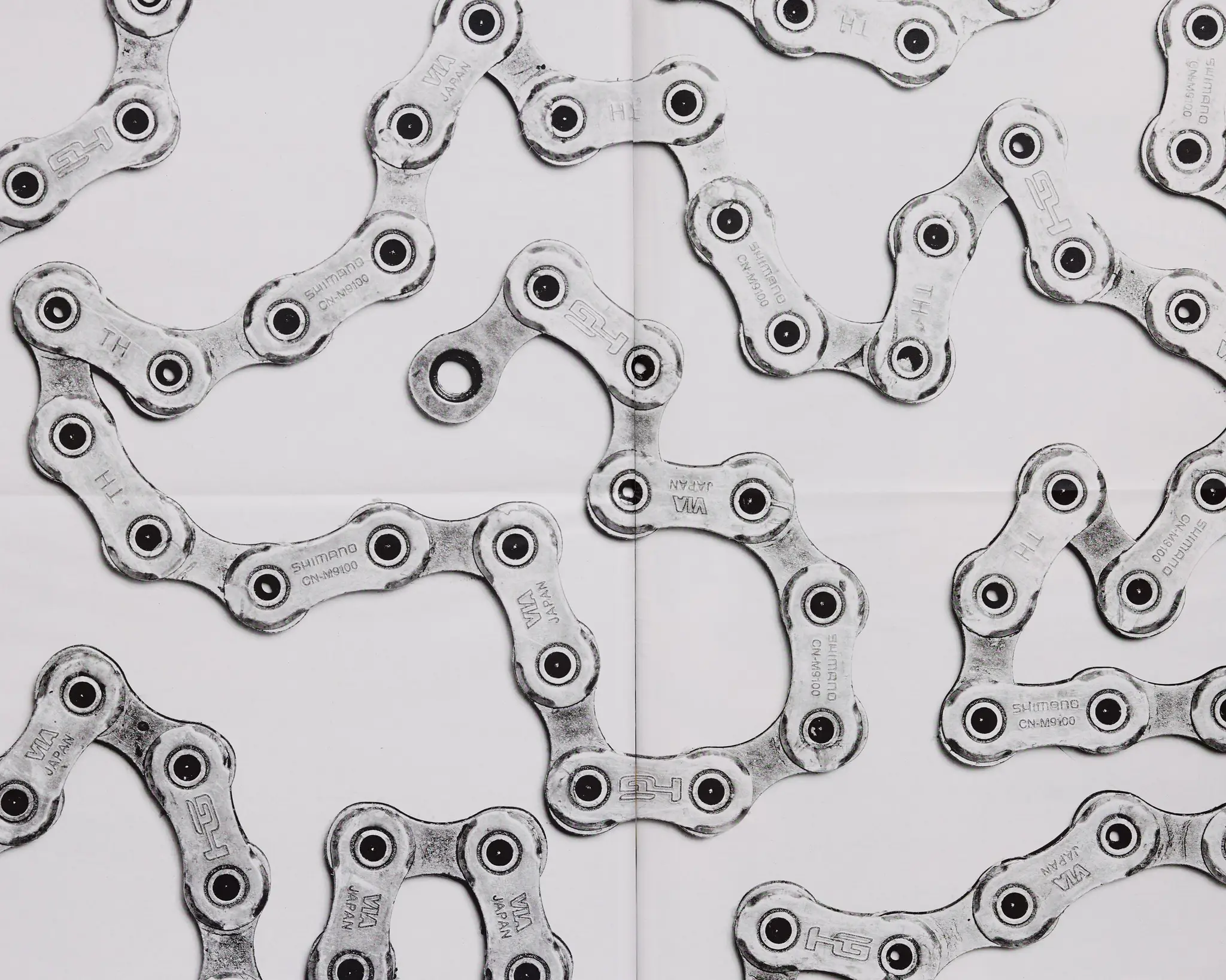 Black and white detail shot of bike chain on a white backdrop. The Rift gravel bike race takes place in Iceland annually. Shot for a personal project and self-published tabloid size newsprint that covers The Rift Gravel Bike Race in Iceland in 2023.