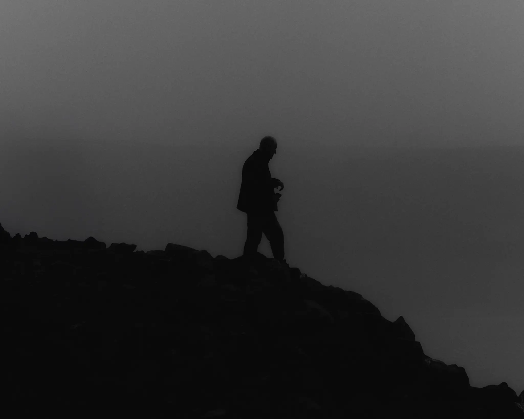 Tourist overlooking the JÖKULSÁRLÓN glacier lagoon in Iceland. Iceland project was shot and completed over the course of ten days all over the island of Iceland.