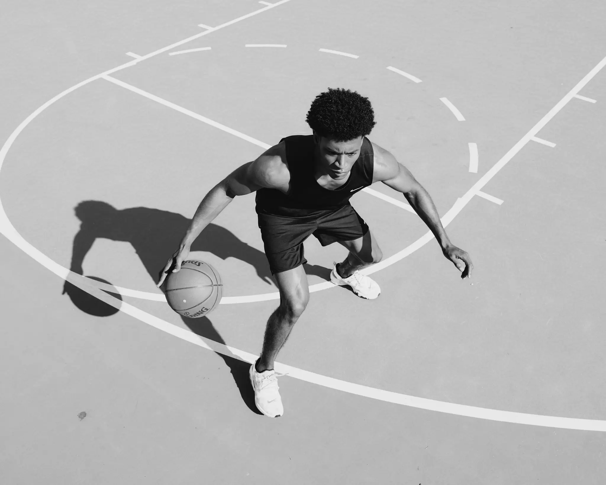 Ivory Williams, model repped by Agency Az, playing basketball and wearing black Nike athletic clothing, Shot for a personal project focused on athletics in Phoenix, AZ in 2023.