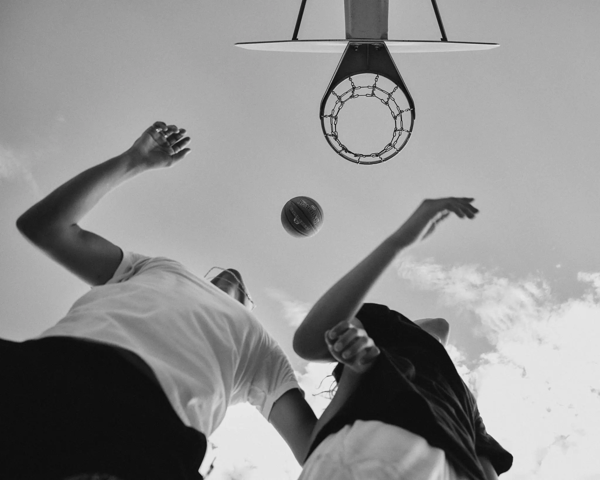 Black and white image of friends playing basketball. On The Court was a personal project that depicts friends coming together to play basketball outside. Shot and completed in Scottsdale, AZ in 2023.