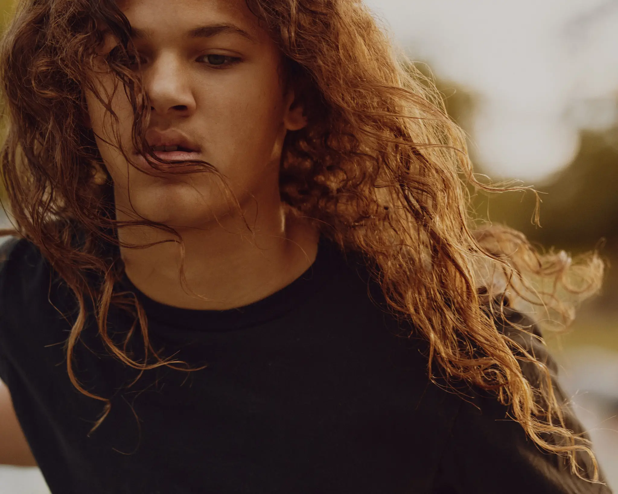 Player dribbling the basketball with hair flowing and backlit. Friends playing basketball. On The Court was a personal project that depicts friends coming together to play basketball outside. Shot and completed in Scottsdale, AZ in 2023.